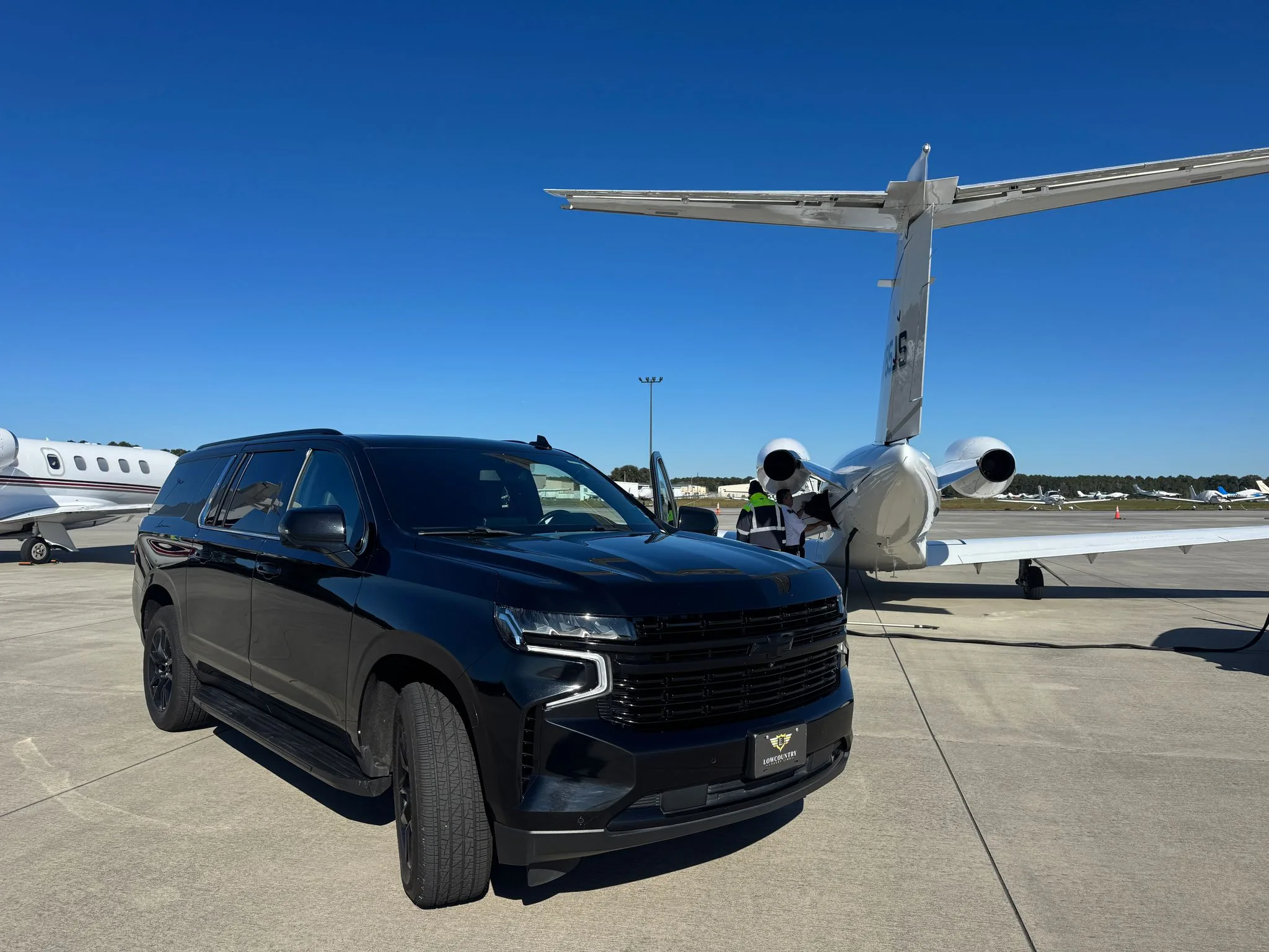 Black Chevrolet Suburban executive SUV from Lowcountry Luxury Limo's fleet parked at Charleston International Airport