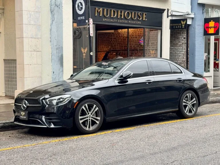 Black Mercedes-Benz E-Class luxury sedan from Lowcountry Luxury Limo's fleet parked in downtown Charleston